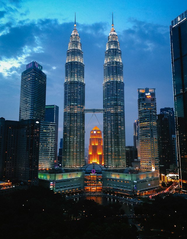 The Petronas Twin Towers lit up at dusk in Kuala Lumpur