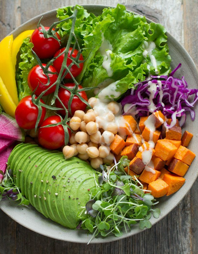 A colourful bowl of fresh vegetables, chickpeas and avocado